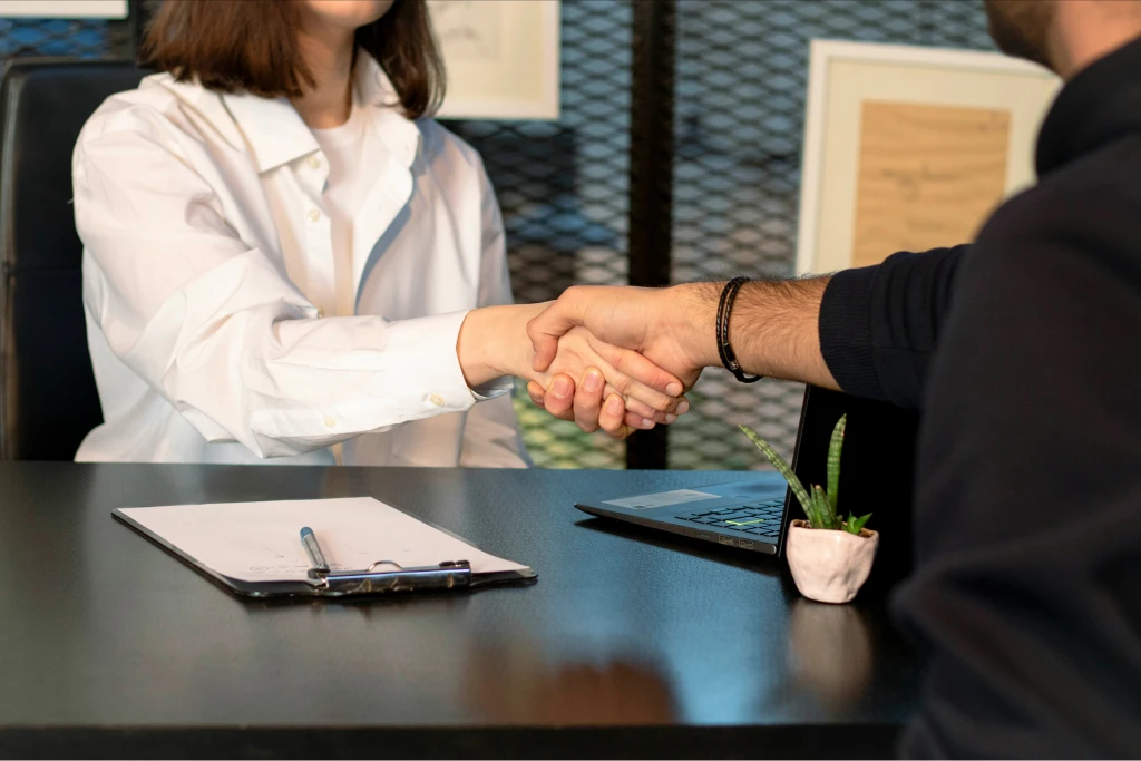 woman doing handshake with man