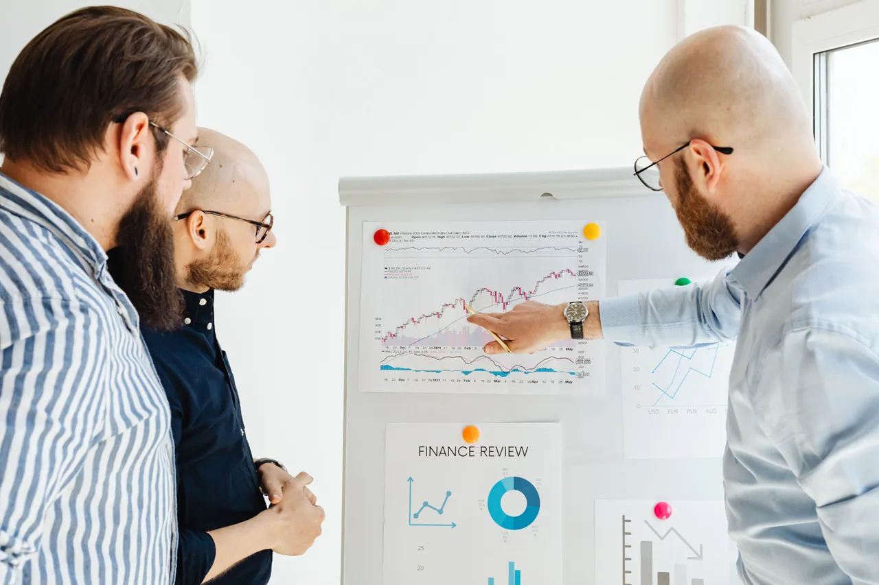 Three people discussing a finance report
