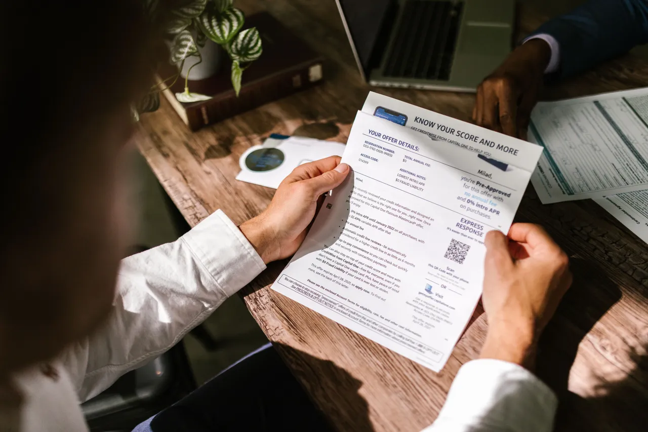 Person reading a document with a financial score