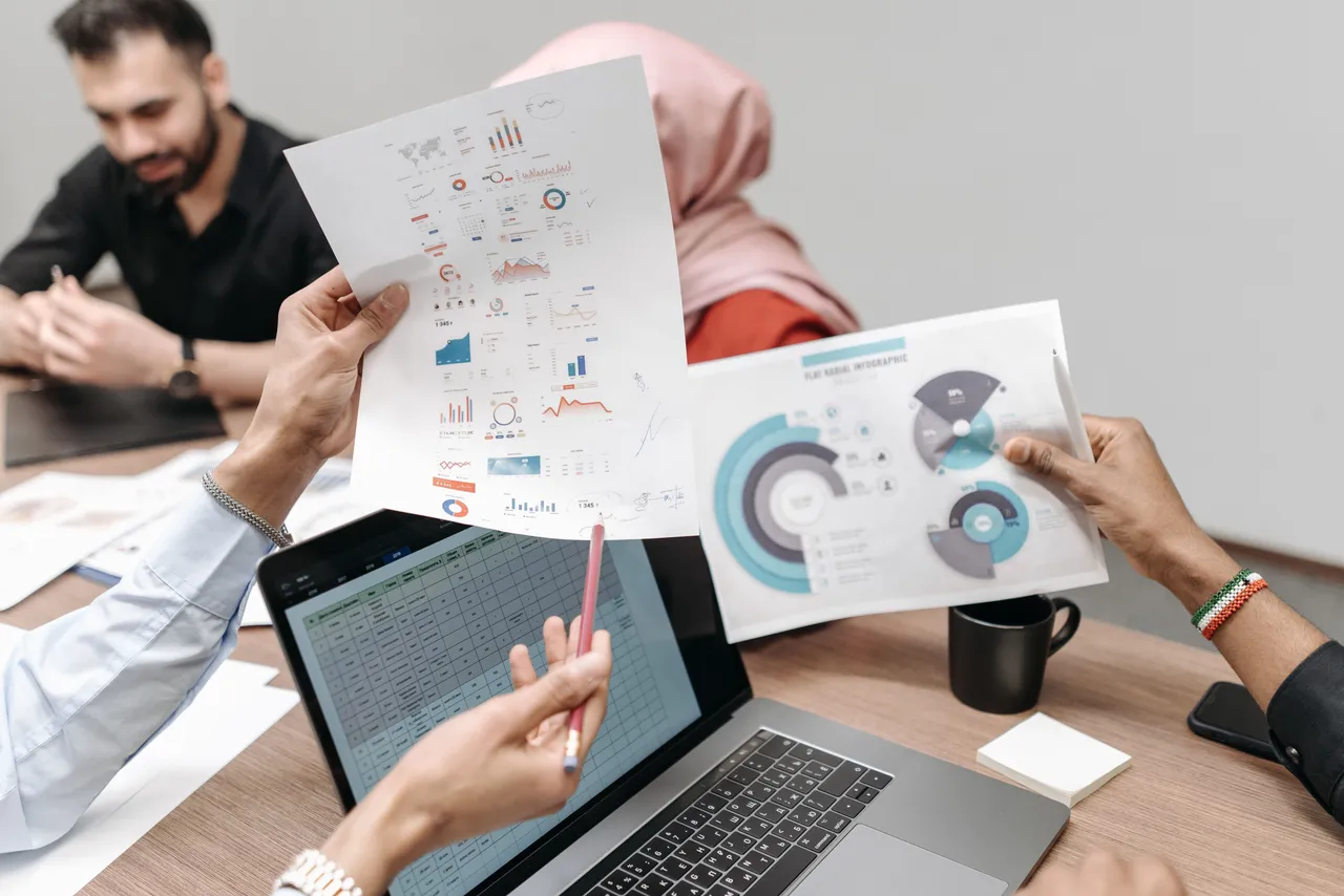 People holding graphs and data on white papers