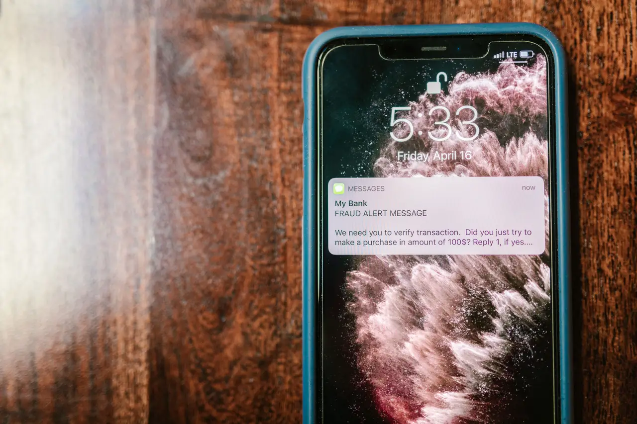 A phone showing a fraud alert message from a bank